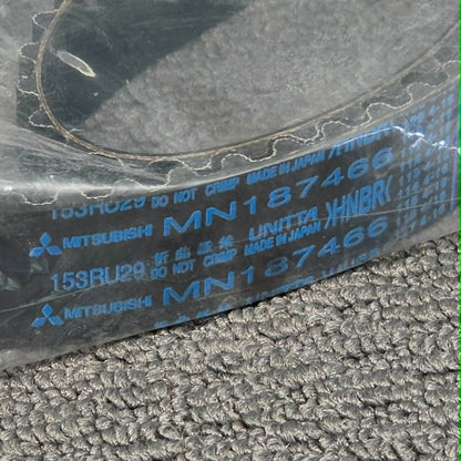 Close-up of a Mitsubishi belt with visible branding on a textured surface